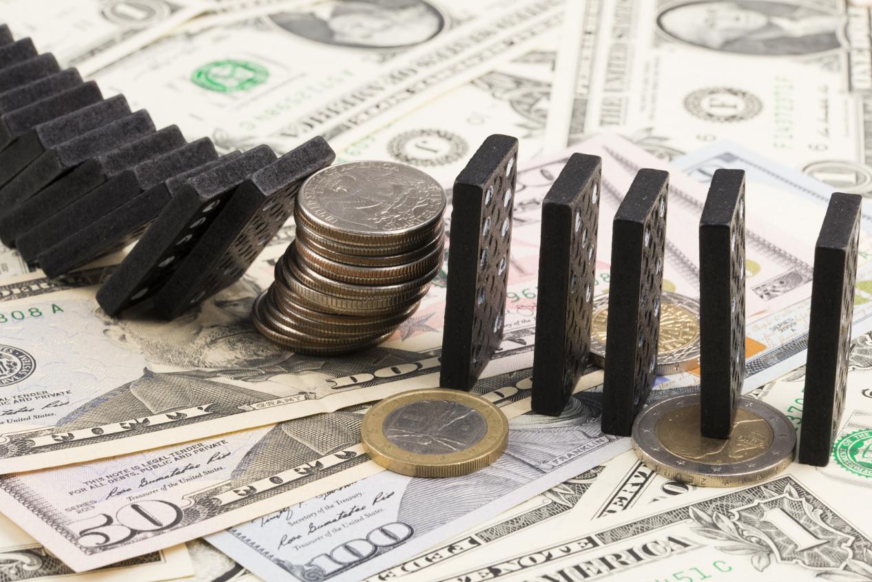 US dollar currency instability concept with stacked coins and dominos