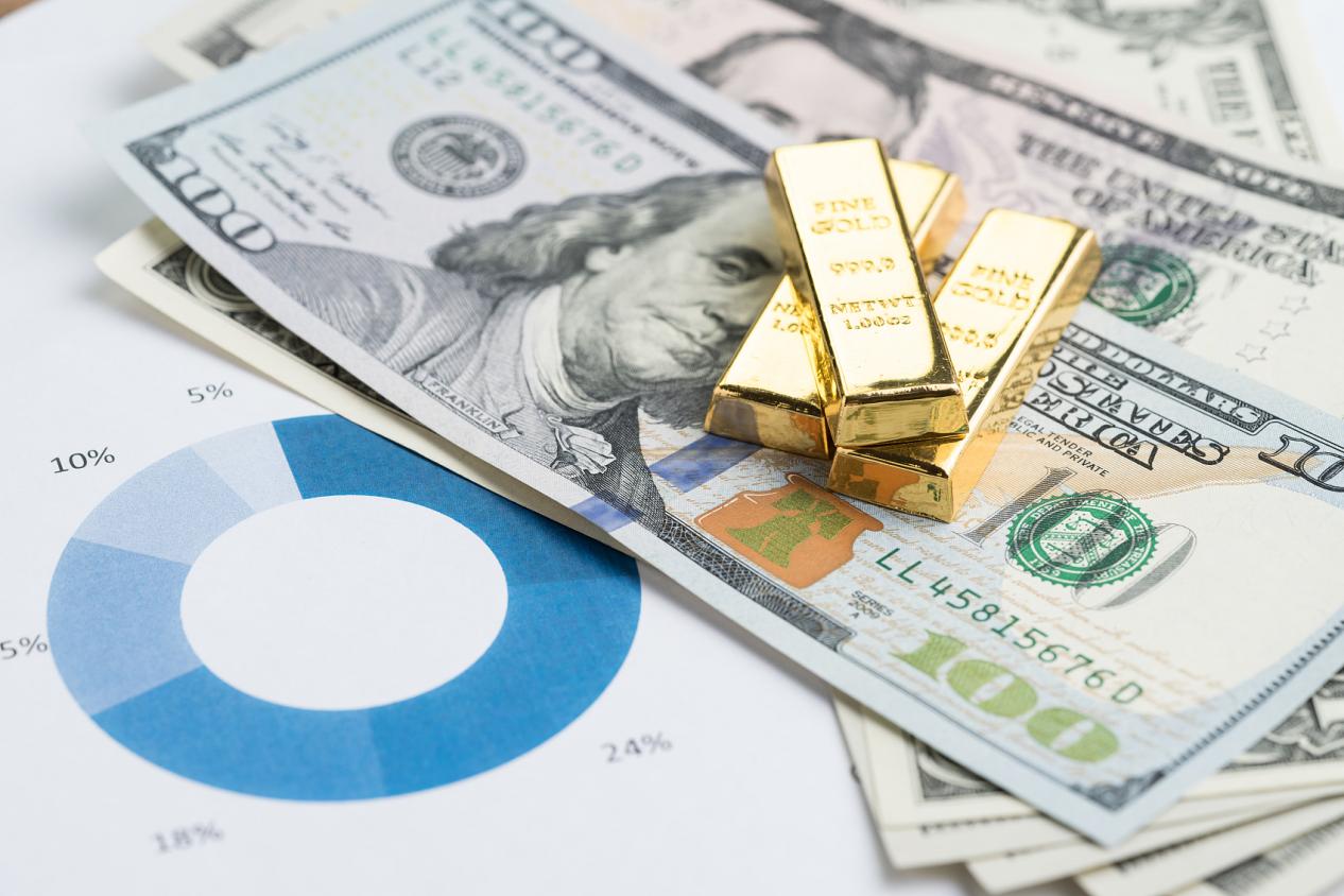 Wealth management or investment asset allocation concept, gold bars  ingot on pile of US dollar ba