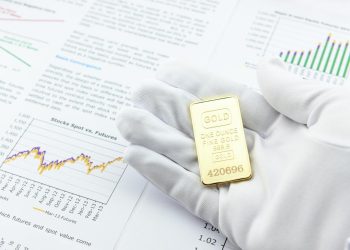 Man with a white handy glove and a gold bar